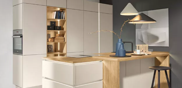 Moderne Nolte Einbauküche mit klaren Fronten in hellen Tönen und warmen Holzakzenten, integrierte Beleuchtung und funktionale Stauraumlösungen, stilvolle Kombination aus Design und Alltagstauglichkeit.